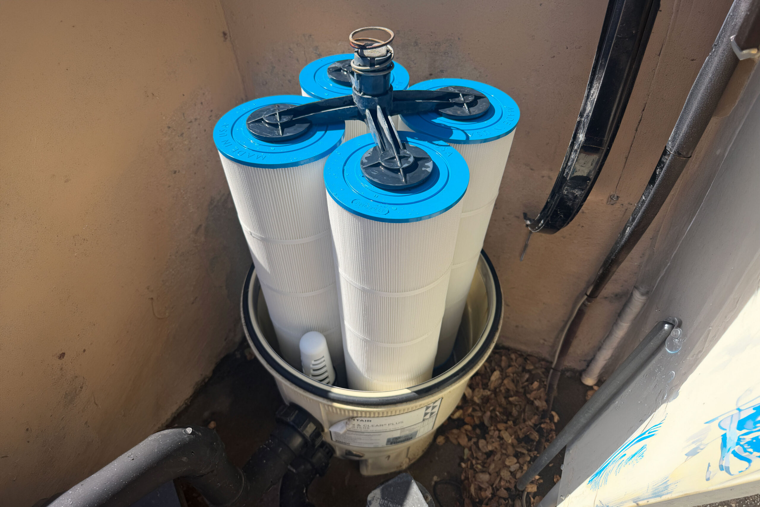 Four pool filter cartridges in the Pentair CCP420 Filter housing. They are clean and new.